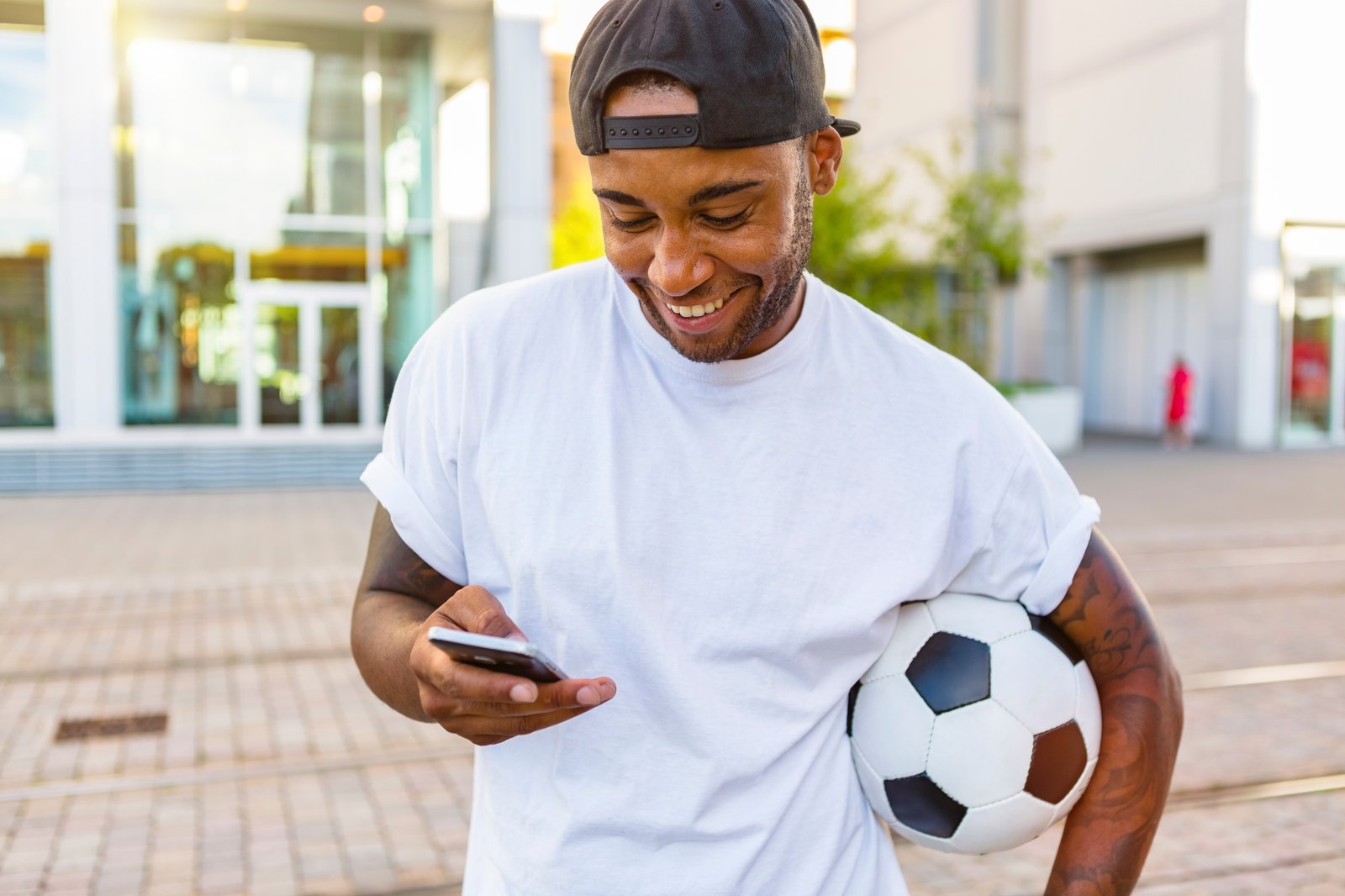 Football bettor checking a phone and setting responsible betting limits