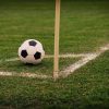 Football beside a corner flag for football betting analysis